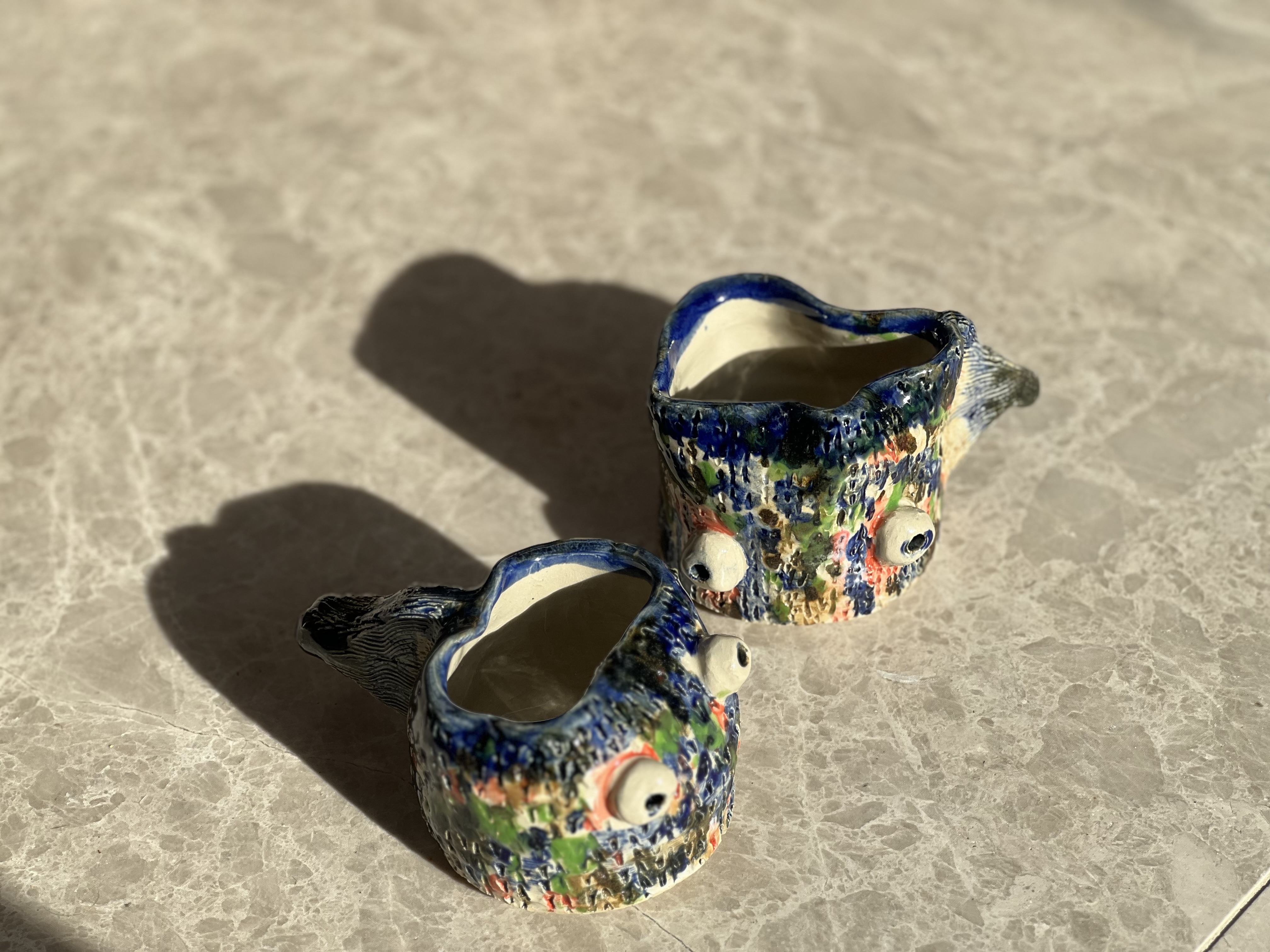 Pair of hand-thrown ceramic fish-shaped mugs